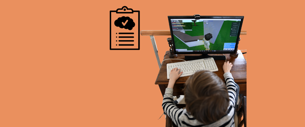 image of young child sitting at a desk and playing Roblox, with the Primer icon next to him.