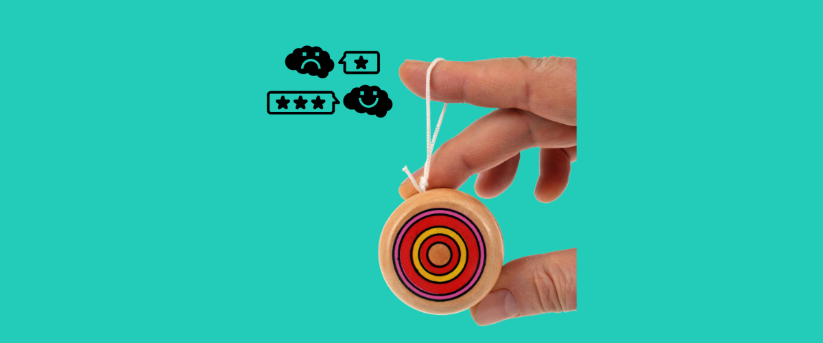 close up of hand holding yo-yo next to reviews icon